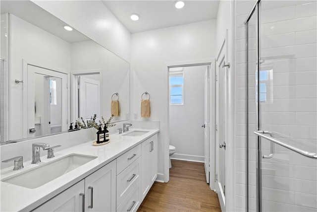 1281 Windmill Rd, Rancho Mission Viejo, CA 92694 - bathroom featuring double vanity, a shower stall, wood finished floors, and recessed lighting