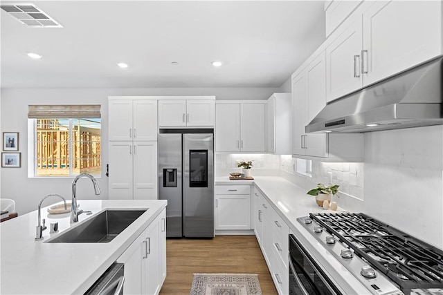 1281 Windmill Rd, Rancho Mission Viejo, CA 92694 - kitchen with stainless steel appliances, under cabinet range hood, light countertops, white cabinets, and recessed lighting