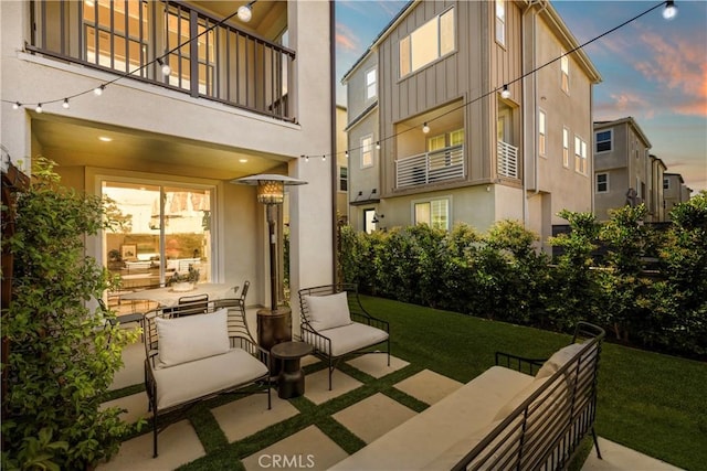 1281 Windmill Rd, Rancho Mission Viejo, CA 92694 - patio terrace at dusk with a balcony and a lawn