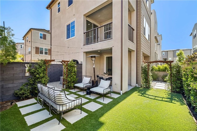1281 Windmill Rd, Rancho Mission Viejo, CA 92694 - back of house with stucco siding, a fenced backyard, a patio area, and a balcony