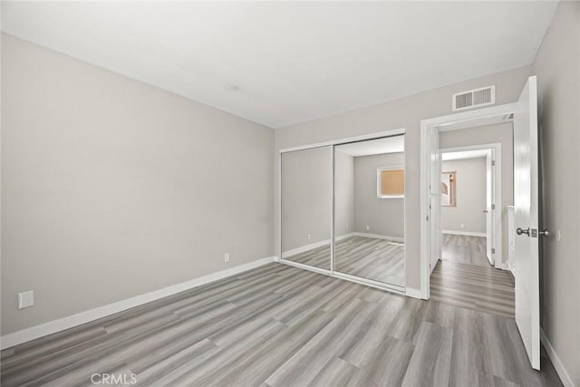 931 W Duarte Rd Unit 6, Arcadia, CA 91007 - unfurnished bedroom with light wood-style flooring and a closet