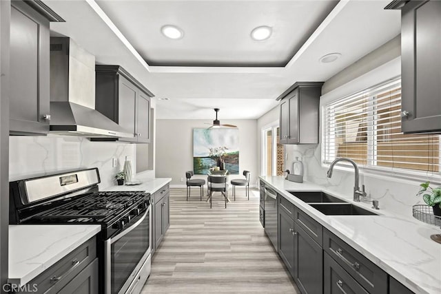 931 W Duarte Rd Unit 6, Arcadia, CA 91007 - kitchen featuring appliances with stainless steel finishes, wall chimney range hood, a tray ceiling, tasteful backsplash, and recessed lighting