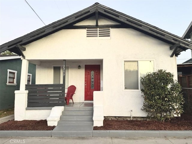 2959 Arlington Ave, Los Angeles, CA 90018 - view of front of house with a porch and stucco siding