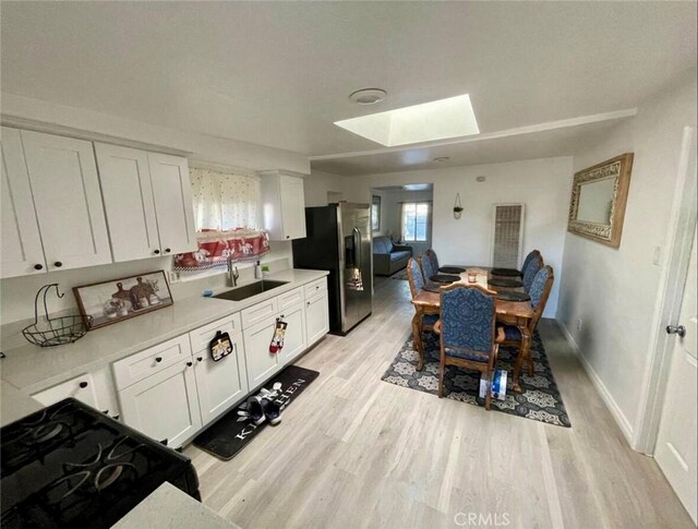 10945-10953 Campbell Ave, Riverside, CA 92505 - dining space featuring a skylight and light wood finished floors