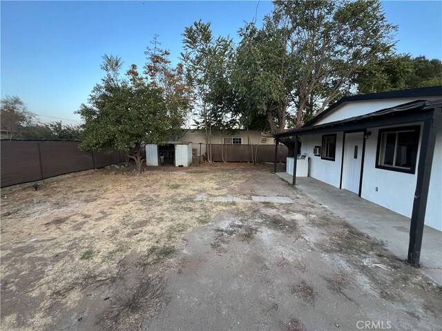 10945-10953 Campbell Ave, Riverside, CA 92505 - fenced backyard featuring a storage shed and a patio area