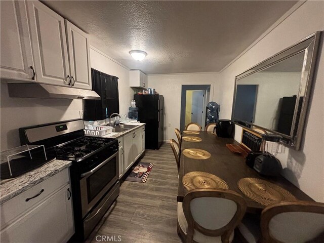 10945-10953 Campbell Ave, Riverside, CA 92505 - kitchen featuring stainless steel range with gas stovetop, freestanding refrigerator, under cabinet range hood, dark wood-style floors, and a textured ceiling