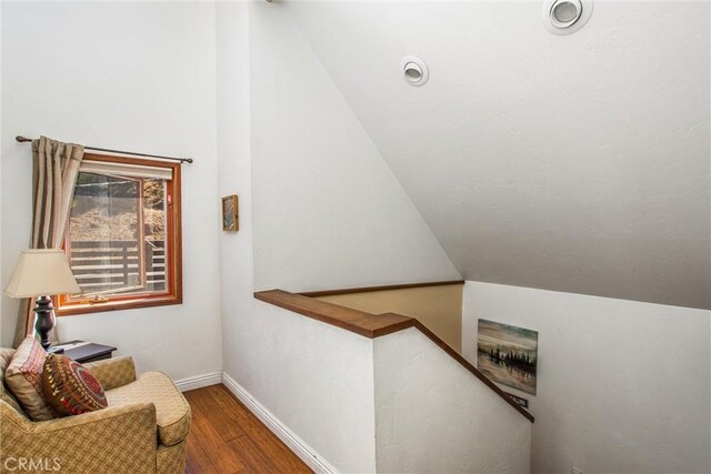 30421 Live Oak Dr, Running Springs, CA 92382 - staircase featuring vaulted ceiling and wood finished floors