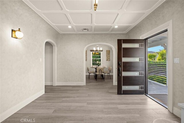 10210 Green St Unit 10210B, Temple City, CA 91780 - foyer entrance with arched walkways, a chandelier, wood finished floors, coffered ceiling, and a textured wall