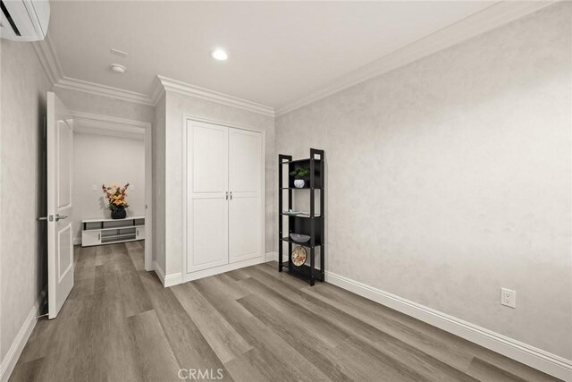 10210 Green St Unit 10210B, Temple City, CA 91780 - bedroom featuring wood finished floors, a wall mounted AC, recessed lighting, crown molding, and a closet