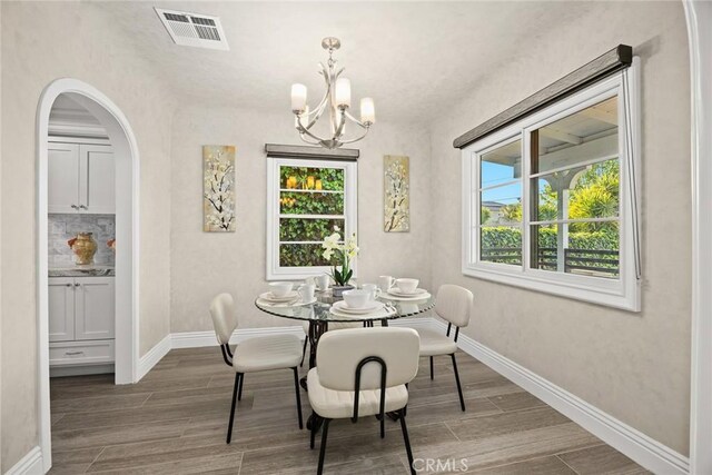 10210 Green St Unit 10210B, Temple City, CA 91780 - dining area featuring a chandelier, wood tiled floors, and arched walkways