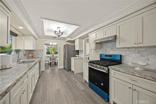 10210 Green St Unit 10210B, Temple City, CA 91780 - kitchen featuring appliances with stainless steel finishes, extractor fan, a chandelier, ornamental molding, and a tray ceiling