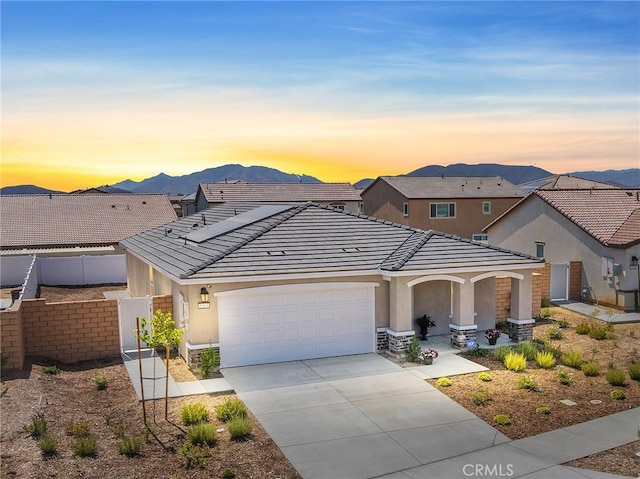 1943 Auger Pl, Hemet, CA 92545 - view of front of house featuring an attached garage, concrete driveway, a tile roof, a porch, and stucco siding
