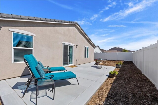 1943 Auger Pl, Hemet, CA 92545 - back of house featuring a fenced backyard, a patio area, and stucco siding