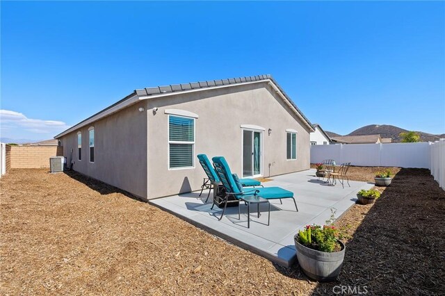 1943 Auger Pl, Hemet, CA 92545 - back of house featuring a fenced backyard, stucco siding, and a patio area