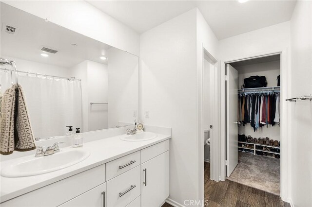 1943 Auger Pl, Hemet, CA 92545 - full bath featuring wood finished floors, double vanity, and a walk in closet