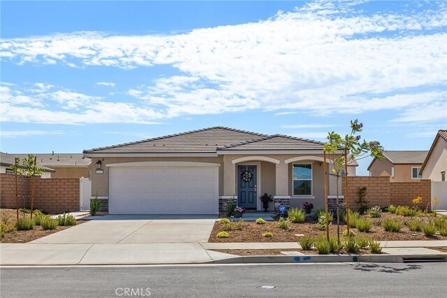 1943 Auger Pl, Hemet, CA 92545 - view of front facade with stucco siding, driveway, a garage, and a tile roof