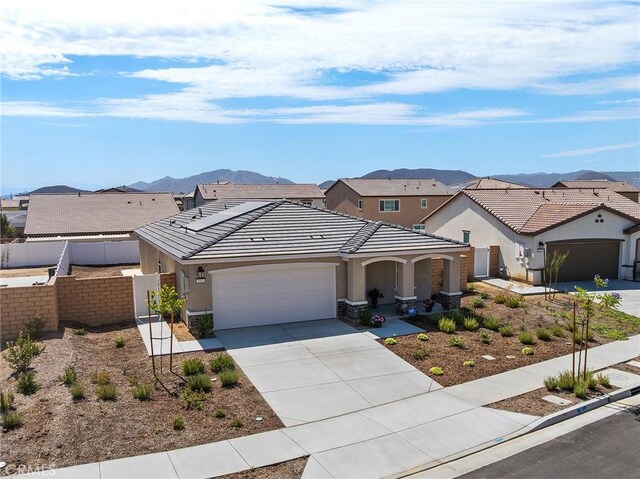 1943 Auger Pl, Hemet, CA 92545 - view of front of home with a garage, stucco siding, concrete driveway, a tile roof, and a mountain view