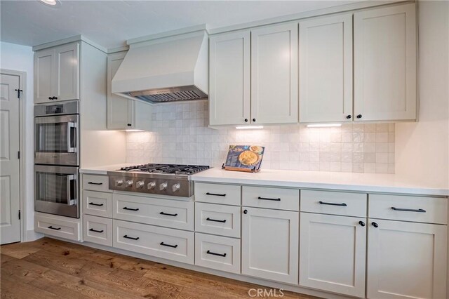 770 Warbler Ct, Merced, CA 95340 - kitchen featuring custom exhaust hood, stainless steel appliances, and light countertops