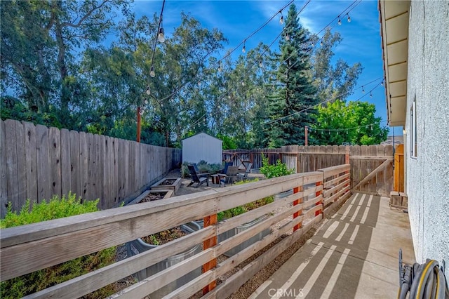 770 Warbler Ct, Merced, CA 95340 - wooden deck featuring a fenced backyard and a storage unit