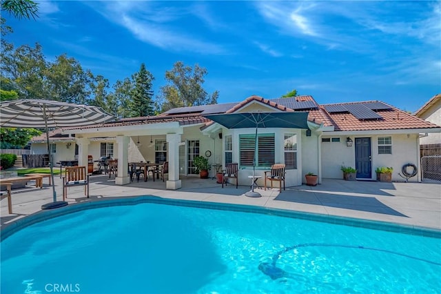 770 Warbler Ct, Merced, CA 95340 - back of property with a patio area, solar panels, and a tile roof