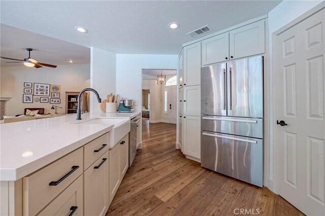 770 Warbler Ct, Merced, CA 95340 - kitchen featuring stainless steel appliances, light wood-style floors, ceiling fan, recessed lighting, and light countertops