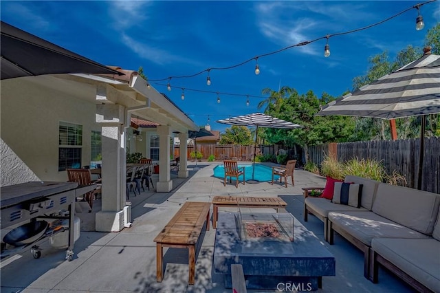 770 Warbler Ct, Merced, CA 95340 - fenced backyard featuring an outdoor living space with a fire pit, a patio, and outdoor dining area