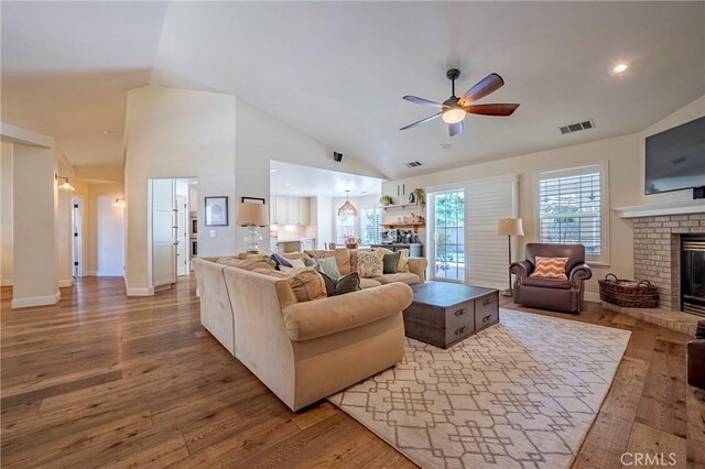770 Warbler Ct, Merced, CA 95340 - living area with a fireplace, ceiling fan, lofted ceiling, and wood finished floors