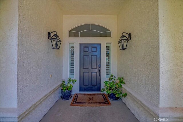 770 Warbler Ct, Merced, CA 95340 - doorway to property featuring stucco siding and covered porch