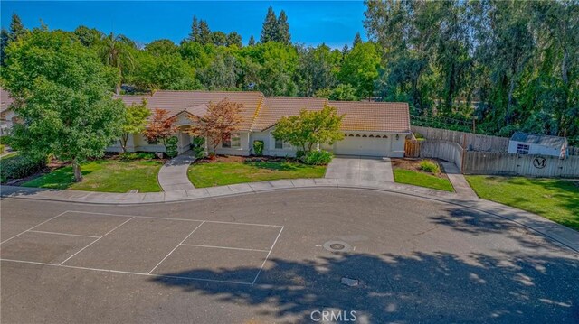770 Warbler Ct, Merced, CA 95340 - view of front of house with a tiled roof, an attached garage, and driveway