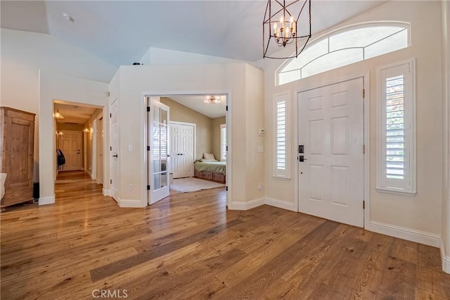 770 Warbler Ct, Merced, CA 95340 - entryway featuring vaulted ceiling, wood finished floors, and a chandelier