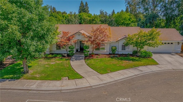 770 Warbler Ct, Merced, CA 95340 - view of front facade featuring a tile roof, an attached garage, driveway, a front lawn, and stucco siding