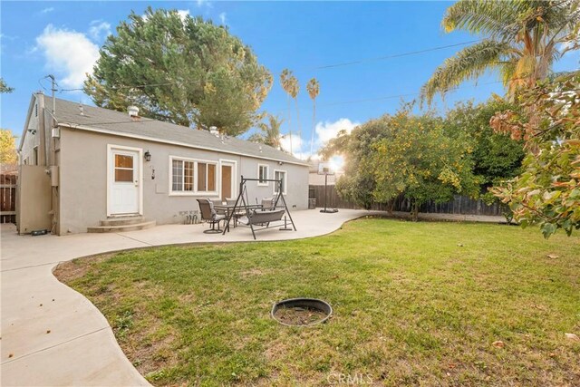 19119 Lemay St, Reseda, CA 91335 - back of property with stucco siding, a fenced backyard, a patio area, and entry steps