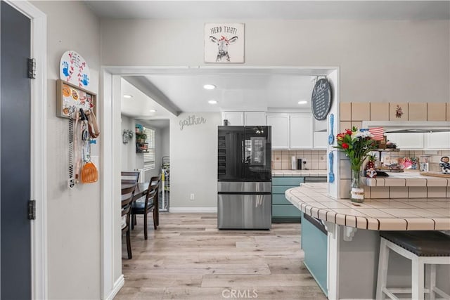 42545 30th St W, Lancaster, CA 93536 - kitchen with smart refrigerator, tile counters, light wood-type flooring, white cabinetry, and recessed lighting
