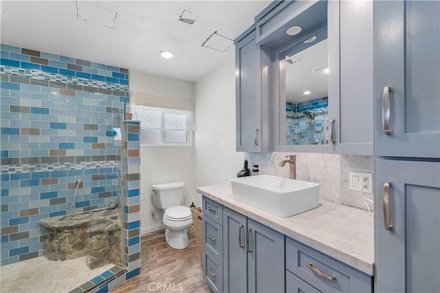 42545 30th St W, Lancaster, CA 93536 - full bath with vanity, wood finished floors, a tile shower, and backsplash