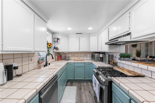 42545 30th St W, Lancaster, CA 93536 - kitchen with stainless steel appliances, tile counters, white cabinetry, and recessed lighting