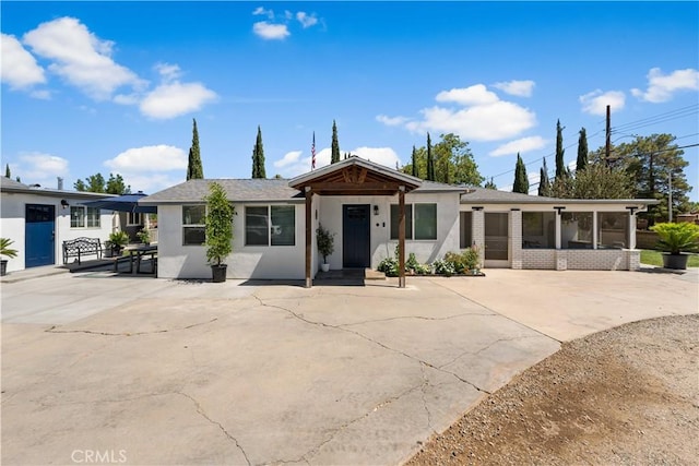 42545 30th St W, Lancaster, CA 93536 - view of front of house with stucco siding and a sunroom