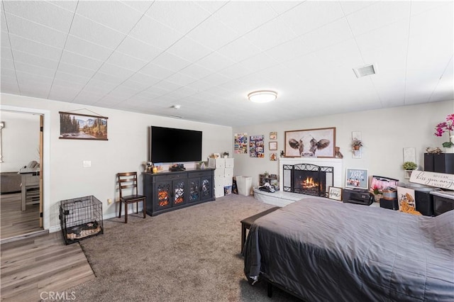 42545 30th St W, Lancaster, CA 93536 - bedroom with a lit fireplace and wood finished floors