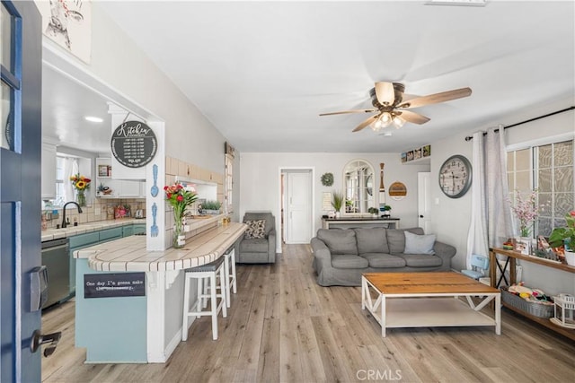 42545 30th St W, Lancaster, CA 93536 - living room featuring plenty of natural light, a ceiling fan, and light wood-style floors