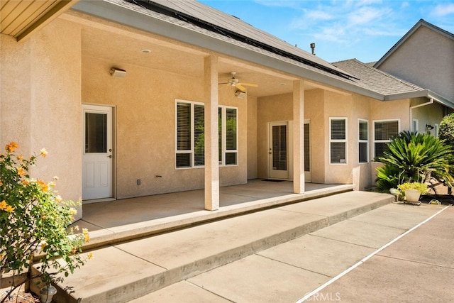 13962 Lindbergh Cir, Chico, CA 95973 - rear view of property with a ceiling fan, a patio area, stucco siding, and roof mounted solar panels