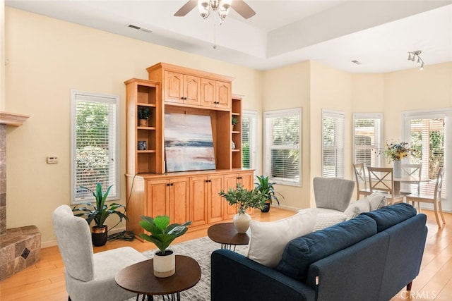 13962 Lindbergh Cir, Chico, CA 95973 - living room with light wood finished floors, ceiling fan, and healthy amount of natural light