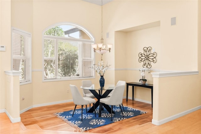13962 Lindbergh Cir, Chico, CA 95973 - dining area with a chandelier, wood finished floors, and a high ceiling