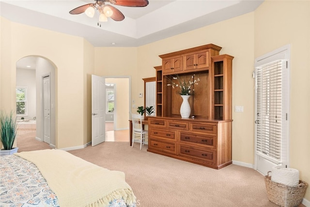 13962 Lindbergh Cir, Chico, CA 95973 - bedroom featuring arched walkways, light carpet, ensuite bath, a ceiling fan, and a towering ceiling