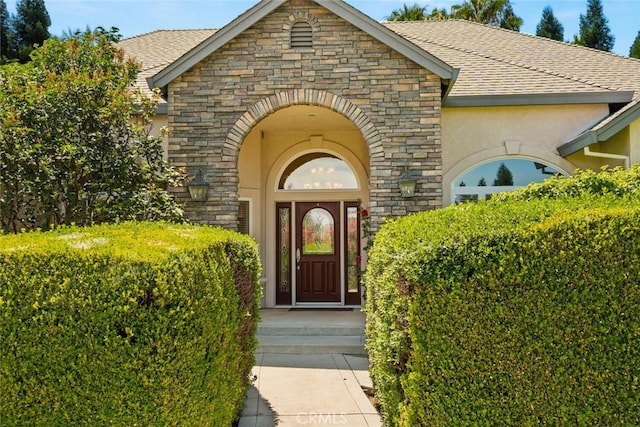 13962 Lindbergh Cir, Chico, CA 95973 - entrance to property with stone siding, a shingled roof, and stucco siding