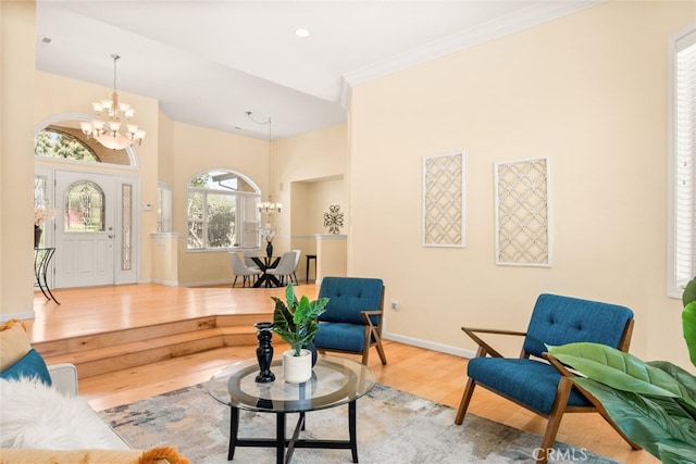 13962 Lindbergh Cir, Chico, CA 95973 - living area with a chandelier, wood finished floors, crown molding, and a towering ceiling