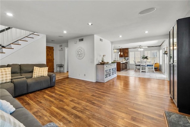 21643 Masterson Ct, Saugus, CA 91350 - living room with light wood-type flooring, stairway, recessed lighting, and ceiling fan