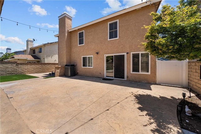21643 Masterson Ct, Saugus, CA 91350 - back of house with stucco siding, a patio, and a chimney