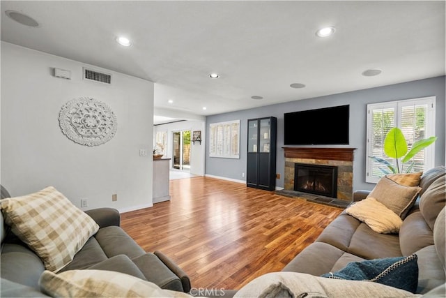 21643 Masterson Ct, Saugus, CA 91350 - living room with wood finished floors, plenty of natural light, a stone fireplace, and recessed lighting