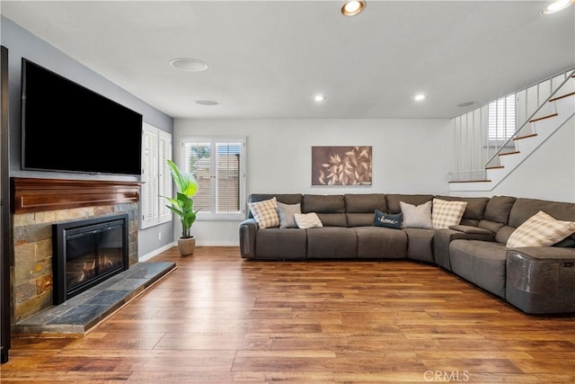 21643 Masterson Ct, Saugus, CA 91350 - living area with wood finished floors, stairs, a high end fireplace, and recessed lighting
