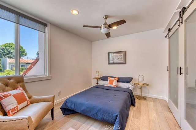 2008 Baja, Newport Beach, CA 92660 - bedroom featuring a barn door, multiple windows, light wood-style flooring, recessed lighting, and a ceiling fan