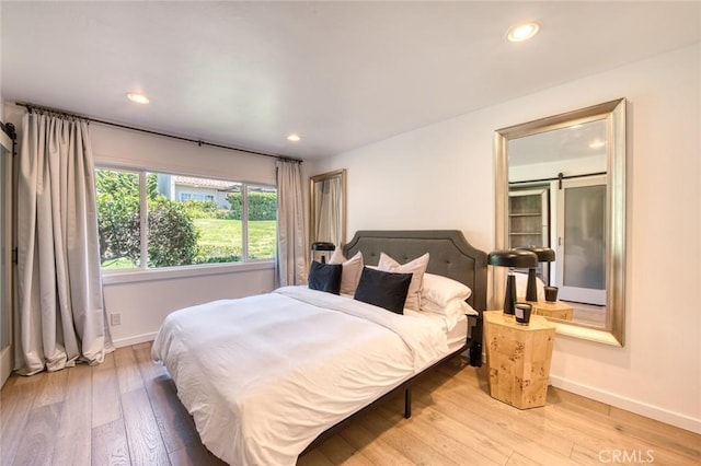 2008 Baja, Newport Beach, CA 92660 - bedroom with light wood-type flooring, a barn door, and recessed lighting